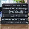 Stack of black decorative books for home decor.
