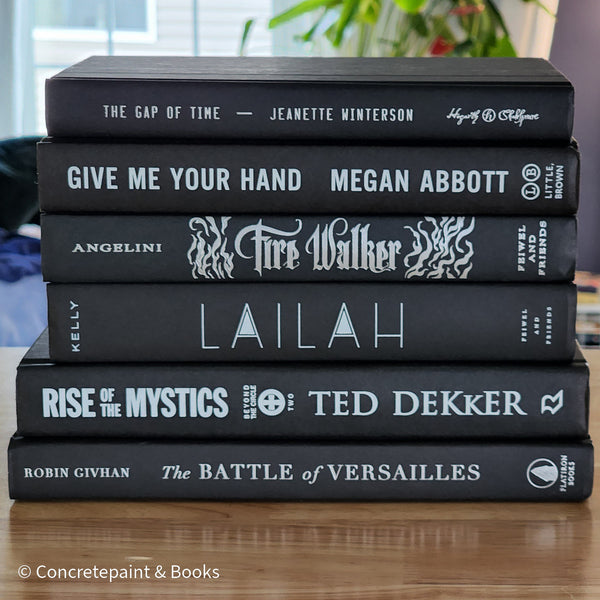 Stack of black decorative books for home decor.