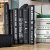 Stack of black decorative books for home decor.