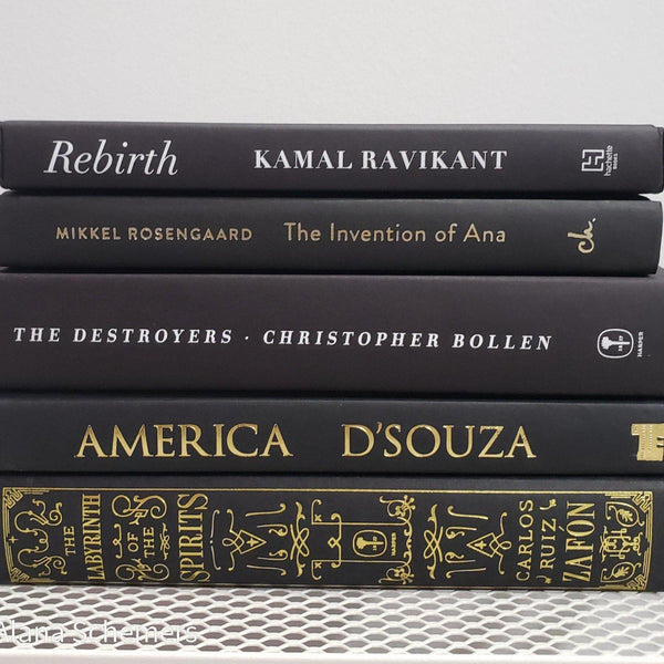 Stack of Black Books Gold & White Accent. Real hardcover books staged and used for decorating.