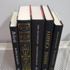 Stack of Black Books Gold & White Accent. Real hardcover books staged and used for decorating.