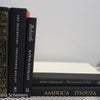 Stack of Black Books Gold & White Accent. Real hardcover books staged and used for decorating.