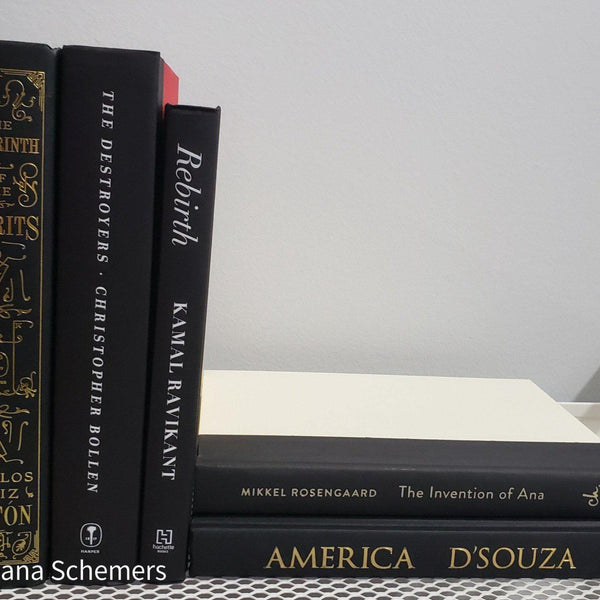 Stack of Black Books Gold & White Accent. Real hardcover books staged and used for decorating.