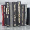 Book Stack Most Vintage & Bookend on glass shelf for display in home. Harcover books in black gray and red. Real books to read or decorate with. 