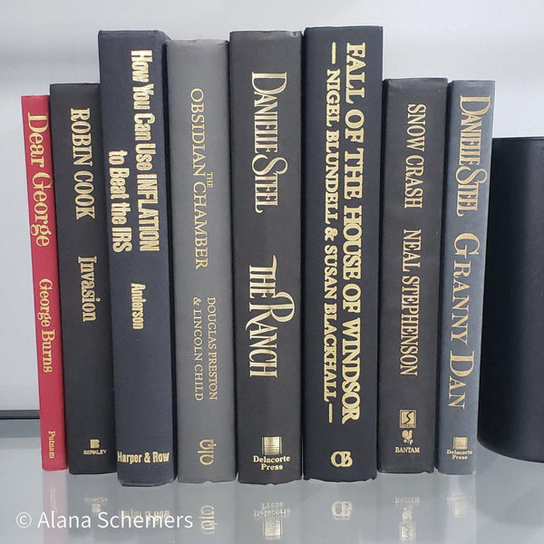 Book Stack Most Vintage & Bookend on glass shelf for display in home. Harcover books in black gray and red. Real books to read or decorate with. 