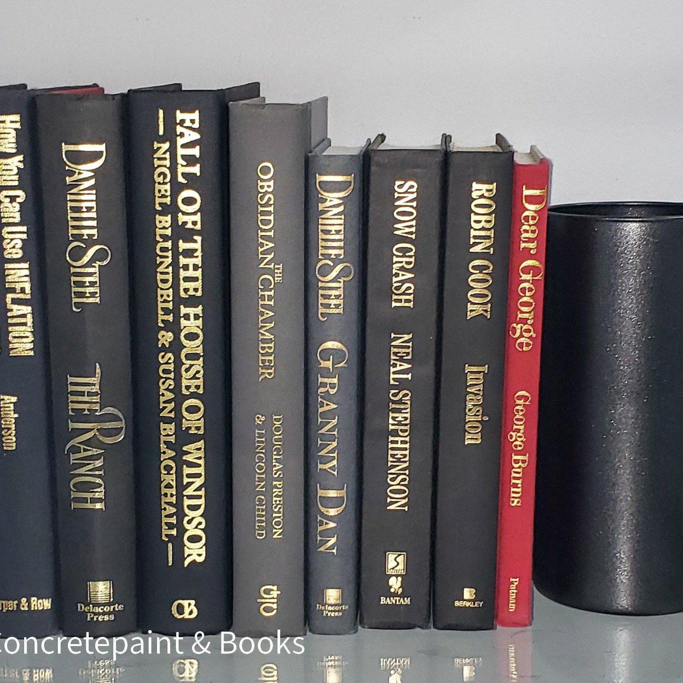 Book Stack Most Vintage & Bookend on glass shelf for display in home. Harcover books in black gray and red. Real books to read or decorate with. 