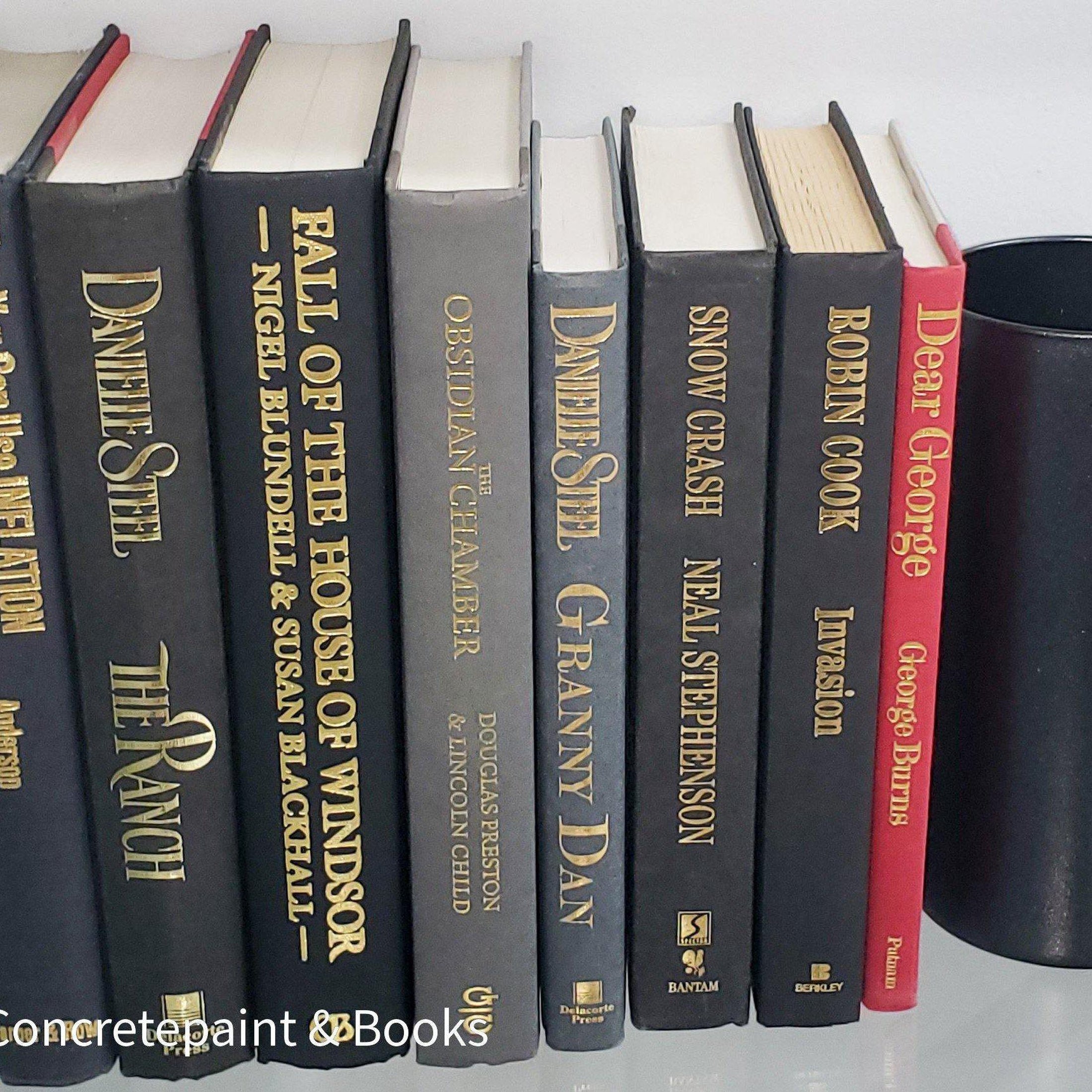 Book Stack Most Vintage & Bookend on glass shelf for display in home. Harcover books in black gray and red. Real books to read or decorate with. 