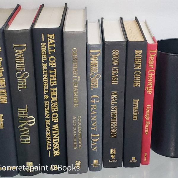 Book Stack Most Vintage & Bookend on glass shelf for display in home. Harcover books in black gray and red. Real books to read or decorate with. 