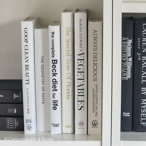 Stack of white decorative cookbooks for display. 
