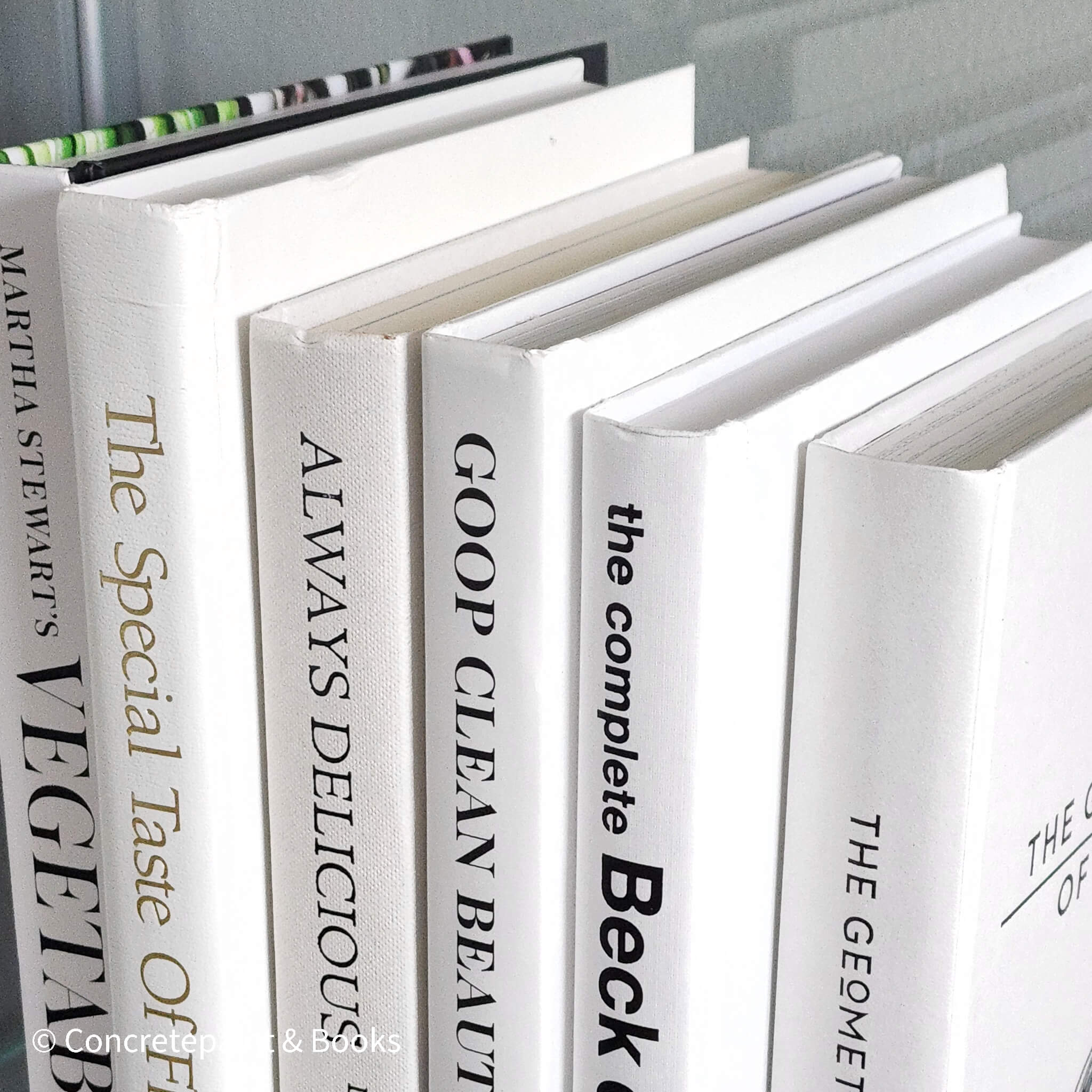 Stack of white decorative cookbooks for display. 