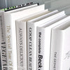 Stack of white decorative cookbooks for display. 