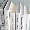 Stack of white decorative cookbooks for display. 