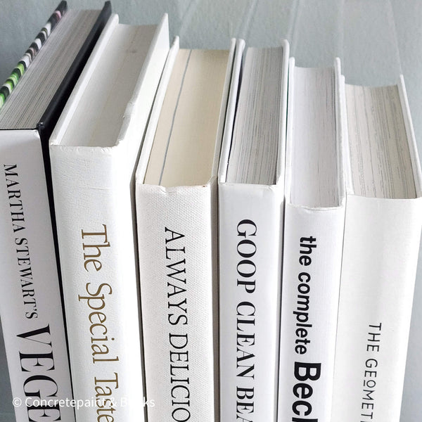 Stack of white decorative cookbooks for display. 