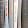 Gray and black books on diplay for mens home decor. 