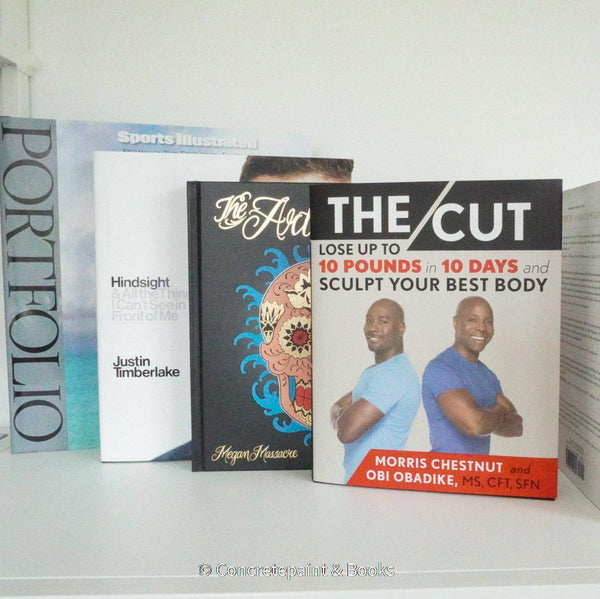 Real books used as home décor. Stack of all black hardcover books including coffee table books, and novels.