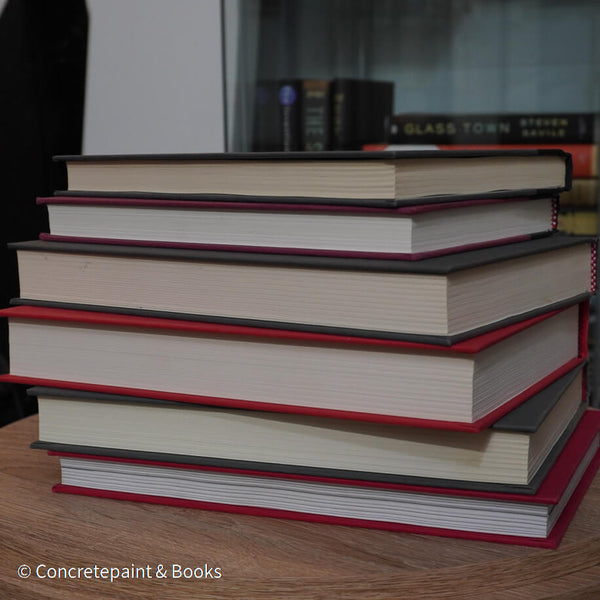 Black, gray, and red books for display. 