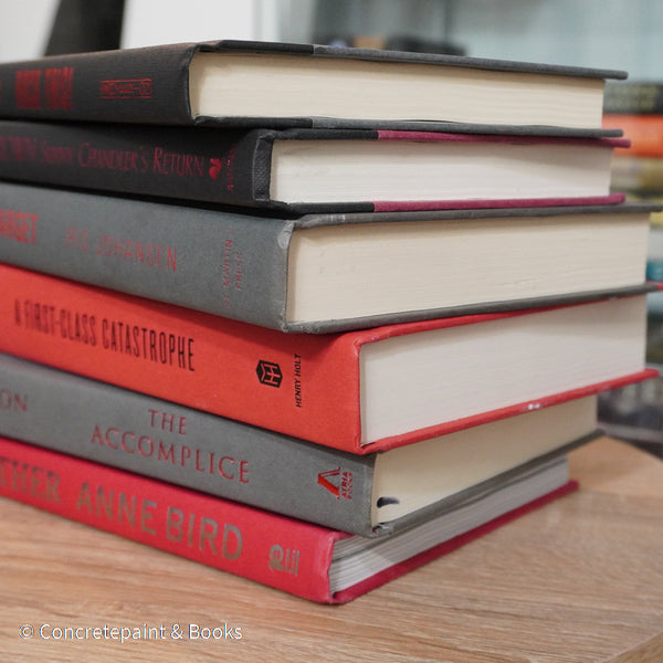 Black, gray, and red books for display. 