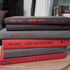 Black, gray, and red books for display. 