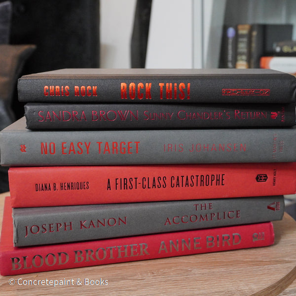 Black, gray, and red books for display. 