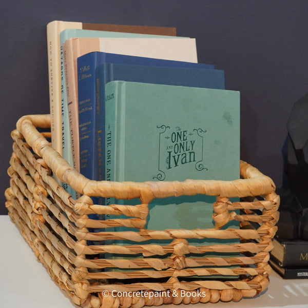 Neutral, mint, and navy color books used for decorating. Stack of real hardcover books for display. 
