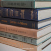 Neutral, mint, and navy color books used for decorating. Stack of real hardcover books for display. 