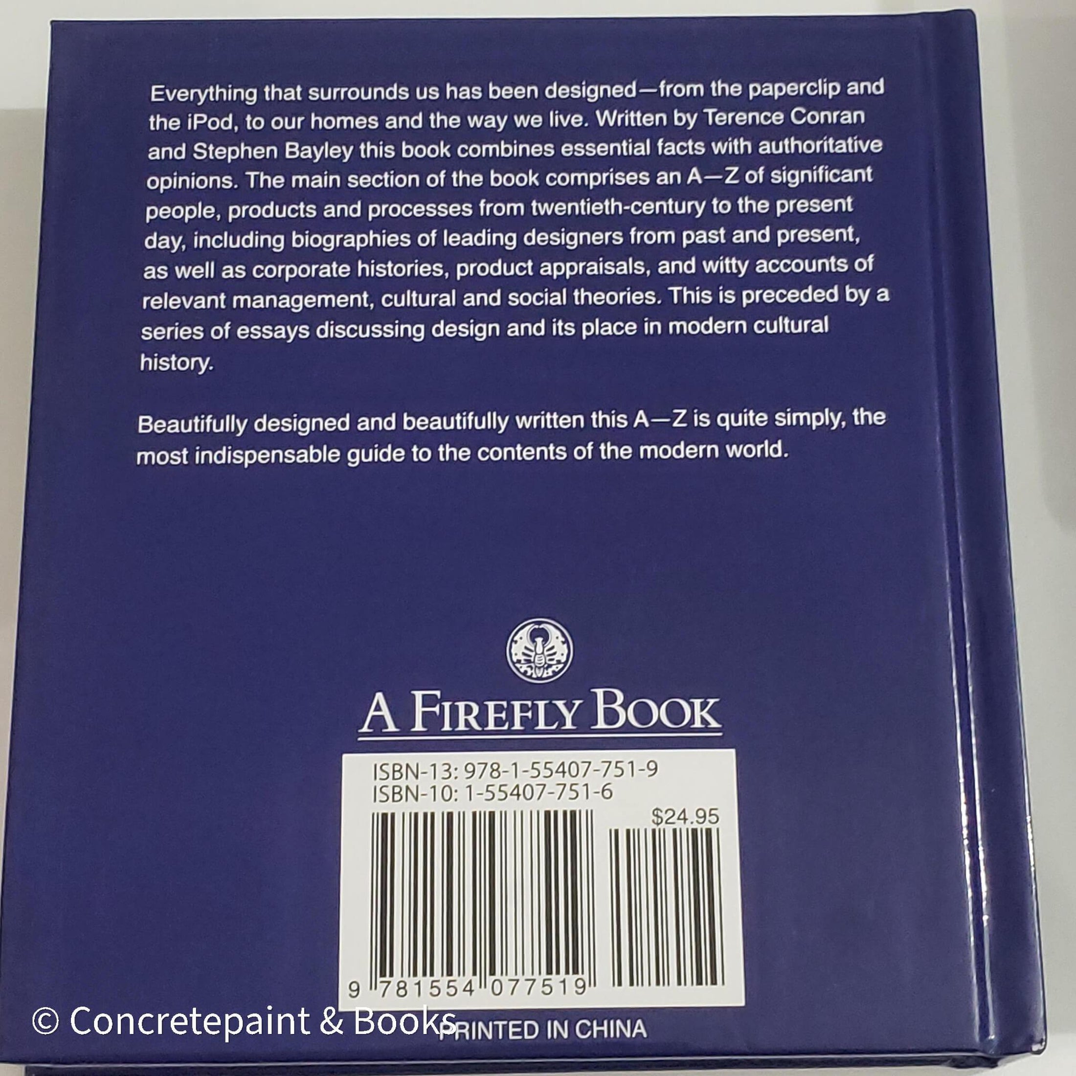 Stack of white and blue hardcover coffee table books. 