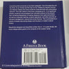 Stack of white and blue hardcover coffee table books. 
