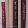 Stack of burgundy, blush, and neutral color books. Real hardcover books used for decorating.