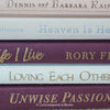 Stack of burgundy, blush, and neutral color books. Real hardcover books used for decorating.