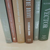 Green and brown books used for shelf decor. 