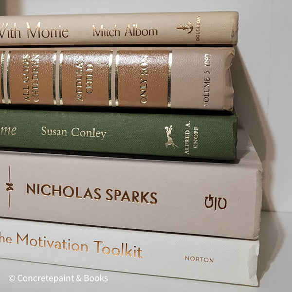 Olive green and neutral books used as shelf decor. Set of books for reading and decorating.