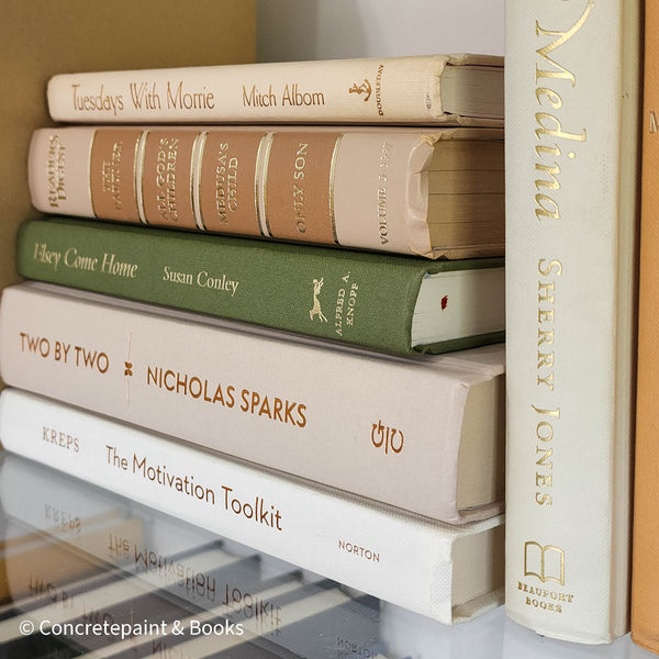 Olive green and neutral books used as shelf decor. Set of books for reading and decorating.