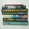 Black and green hardcover real books staged and used as home décor. Book stack on a shelf.