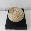 Real headcover books used as staged home décor. Stack of large black coffee table books with ikea seagrass basket on top. Mens bachelor pad decor for sale.