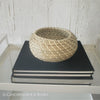 Real headcover books used as staged home décor. Stack of large oblong coffee table books and seagrass ikea basket. Mens bachelor pad decor for sale.