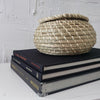 Real headcover books used as staged home décor. Stack of large black oblong coffee table books with ikea seagrass basket. Mens bachelor pad decor for sale.