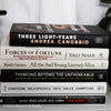 Neutral, sand and white books on display. Real hardcover books for decorating shelves.