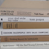 Neutral, sand and white books on display. Real hardcover books for decorating shelves.