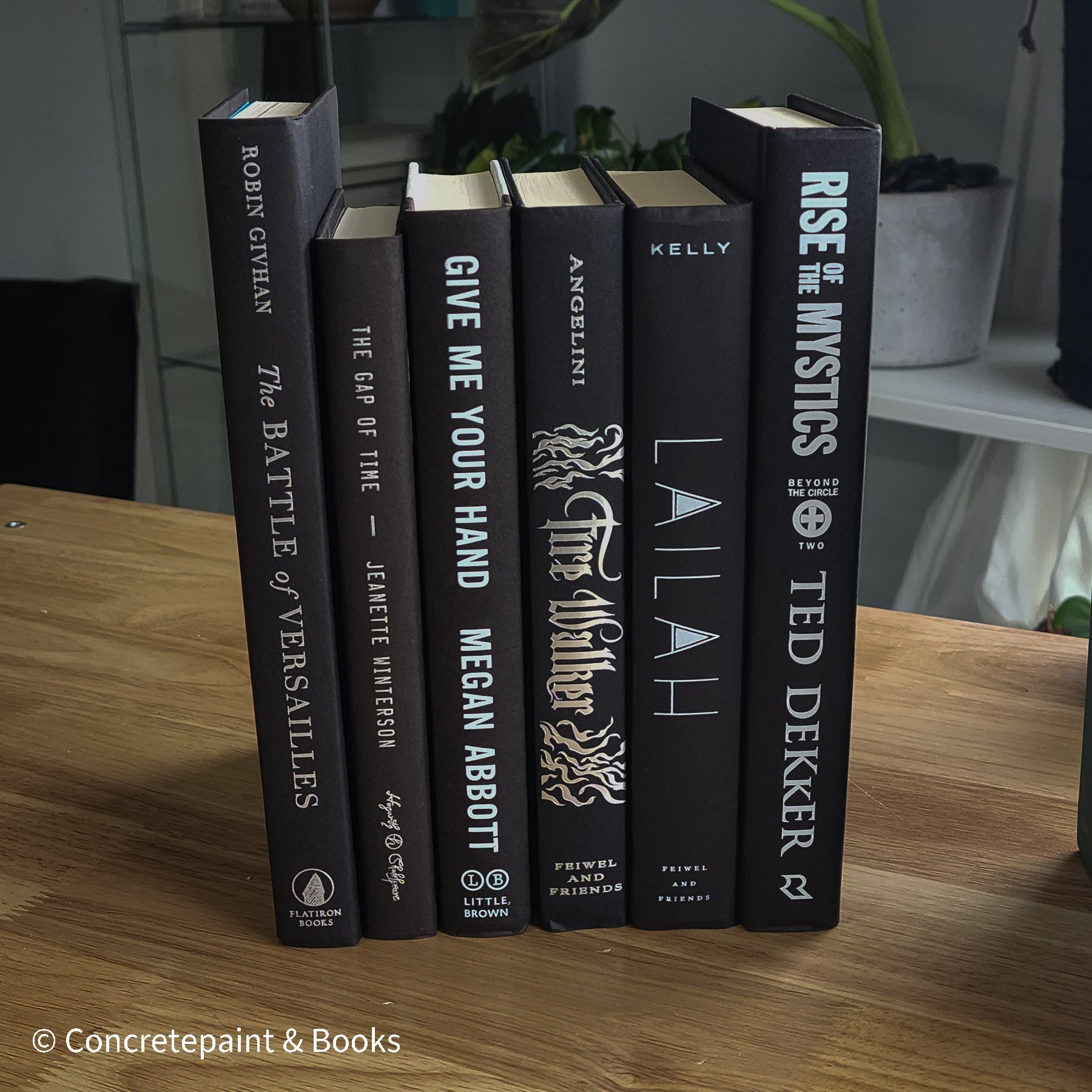 Stack of black decorative books for home decor.