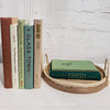 Set of real hardcover books stag3d and us3d as home decor. Decorative tray with green books on top. 