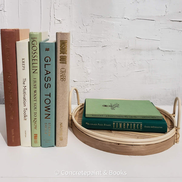 Set of real hardcover books stag3d and us3d as home decor. Decorative tray with green books on top. 