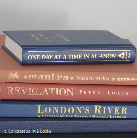 Navy blue and terra-cotta colored books. Decorative books for display. 