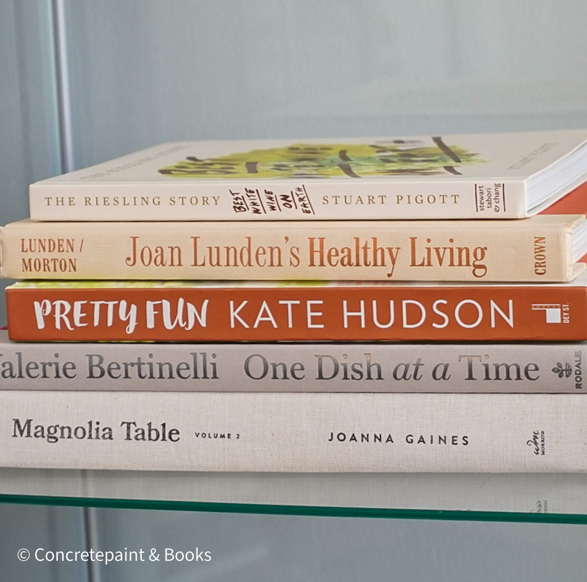 Stack of neutral decorative cookbooks for display. 