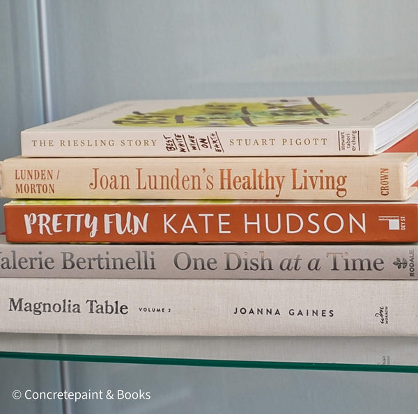 Stack of neutral decorative cookbooks for display. 