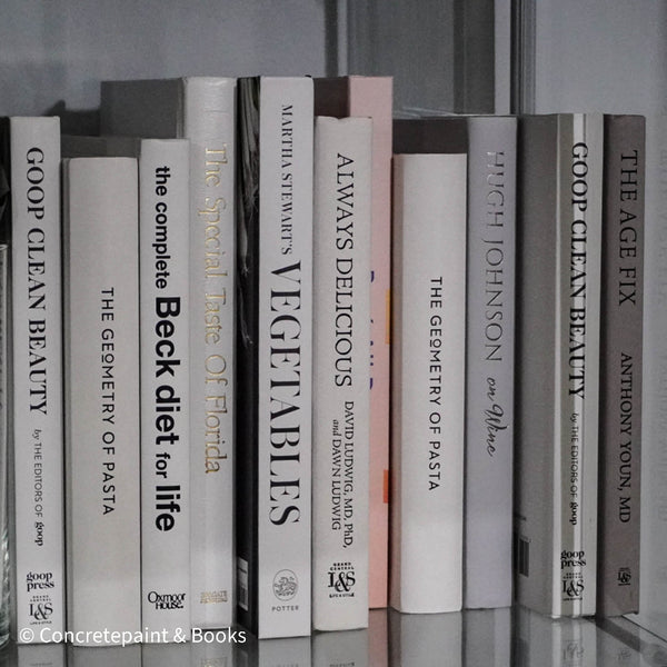 set of white cookbooks on display. Decorative cookbooks set used as black and white kitchen decor. 