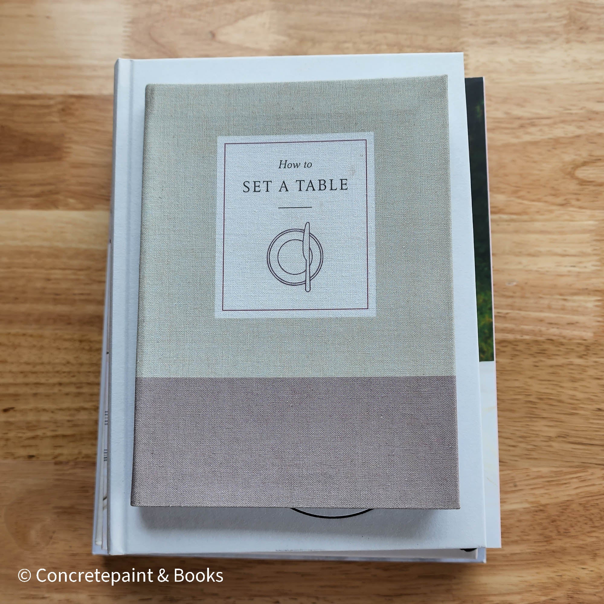stack of cookbooks for decorating kitchen. White and blush kitchen decor. 