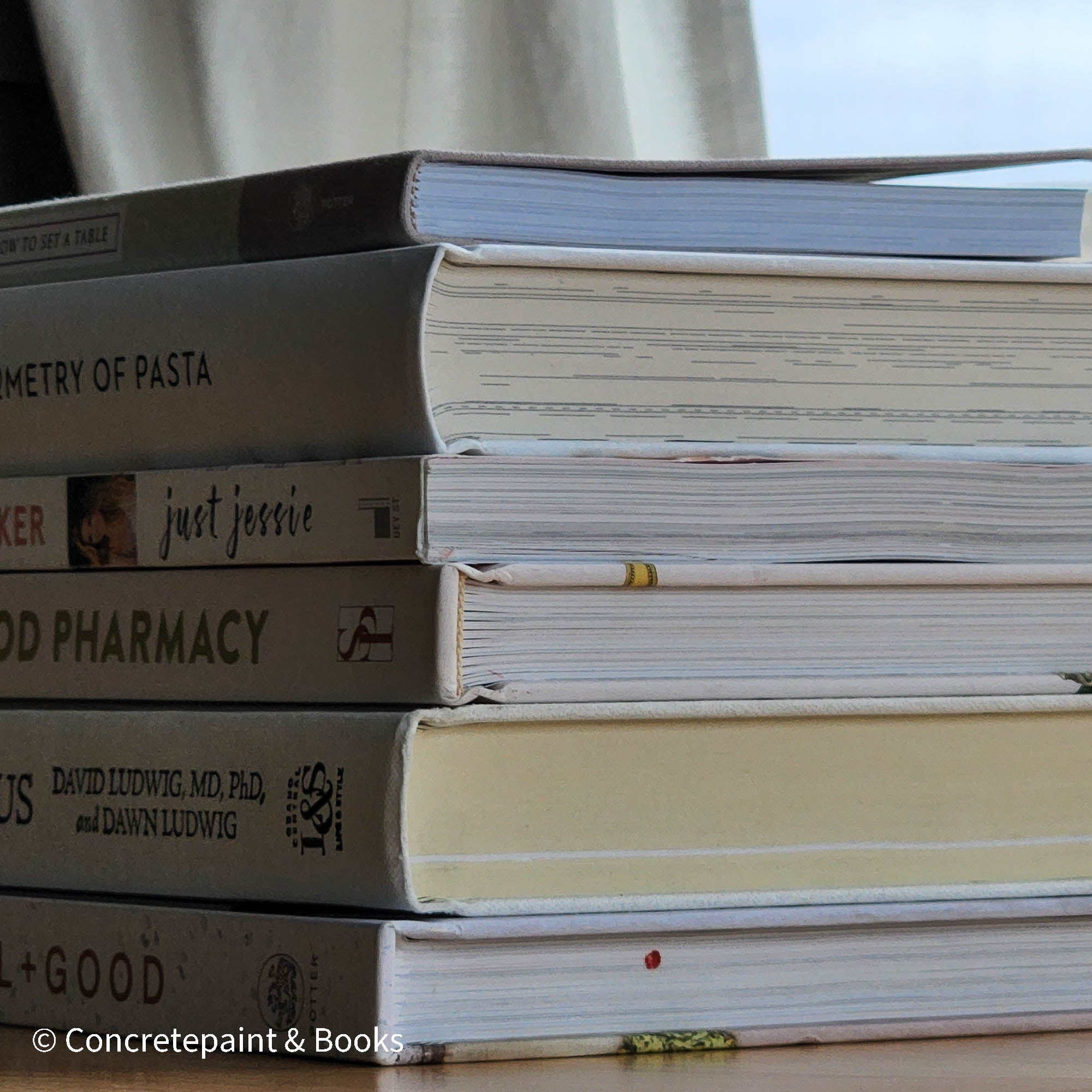 stack of cookbooks for decorating kitchen. White and blush kitchen decor. 