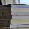 stack of cookbooks for decorating kitchen. White and blush kitchen decor. 