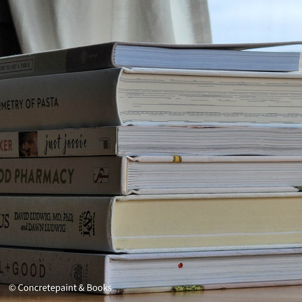 stack of cookbooks for decorating kitchen. White and blush kitchen decor. 
