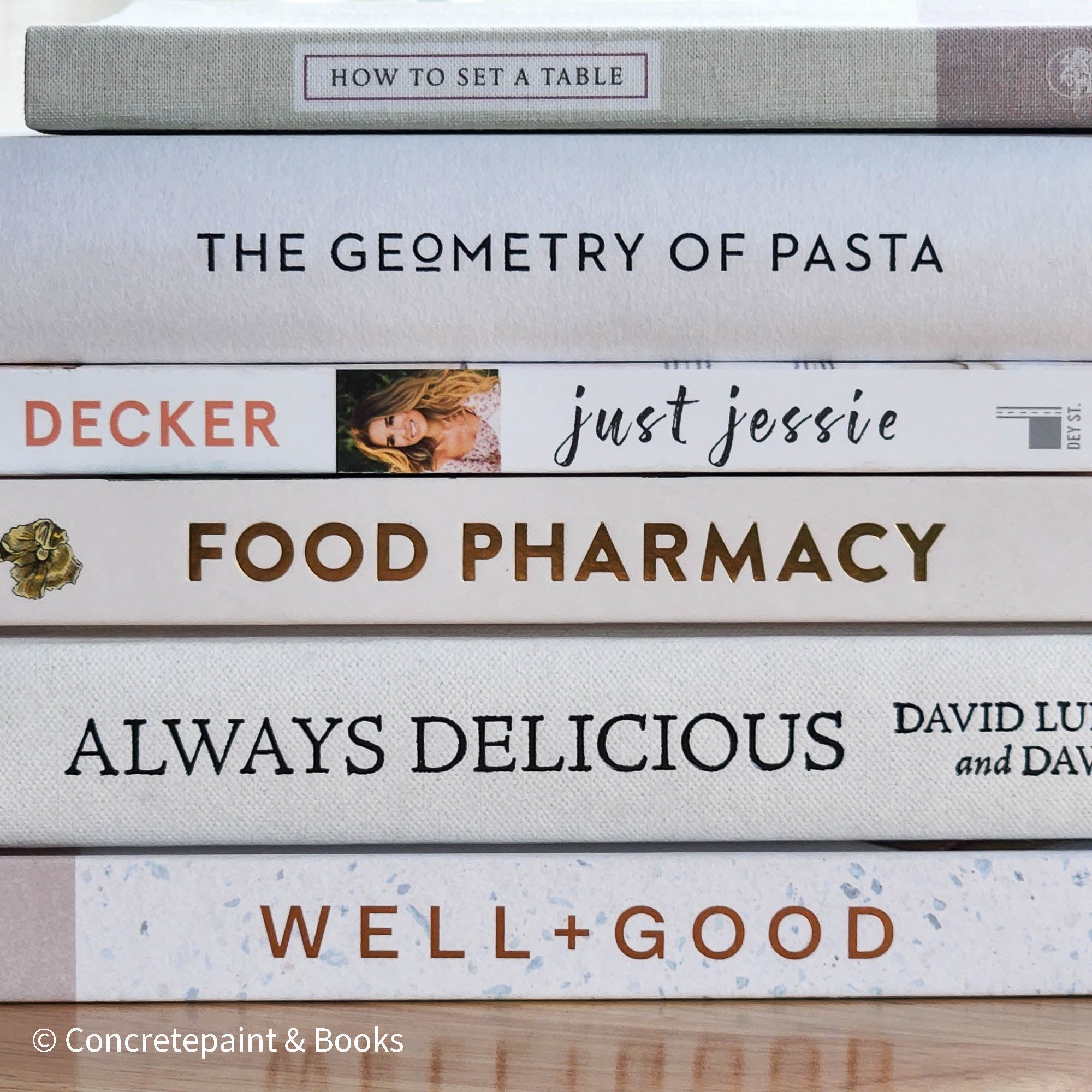 stack of cookbooks for decorating kitchen. White and blush kitchen decor. 